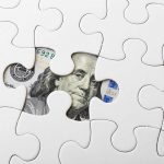 White puzzle and US banknote